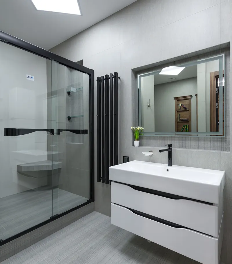 Glass shower door with a matte black frame