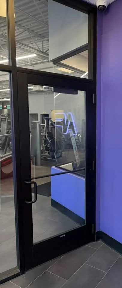 Glass storefront door with a dark aluminum frame